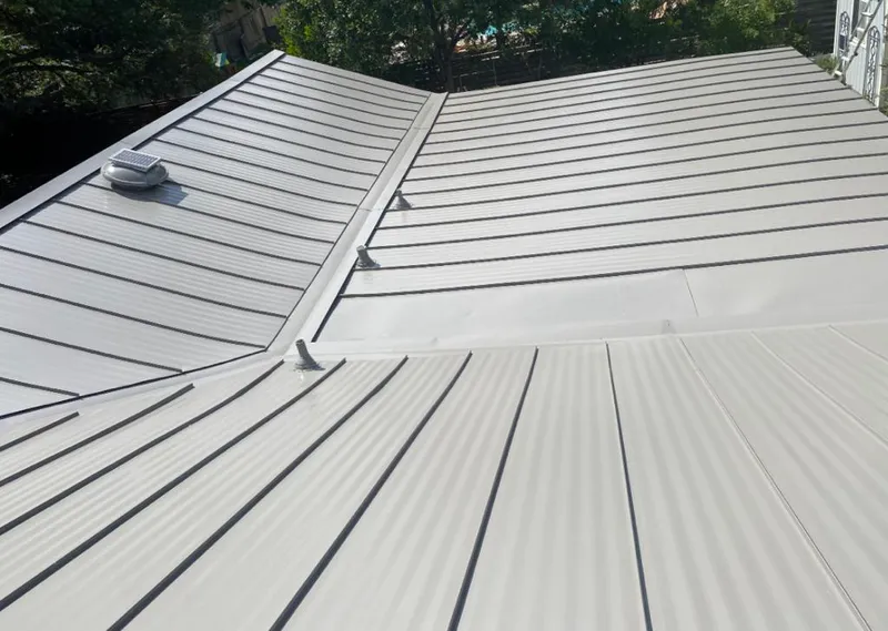 Solar attic fan installed on a metal roof for Roof Ventilation in Luzerne